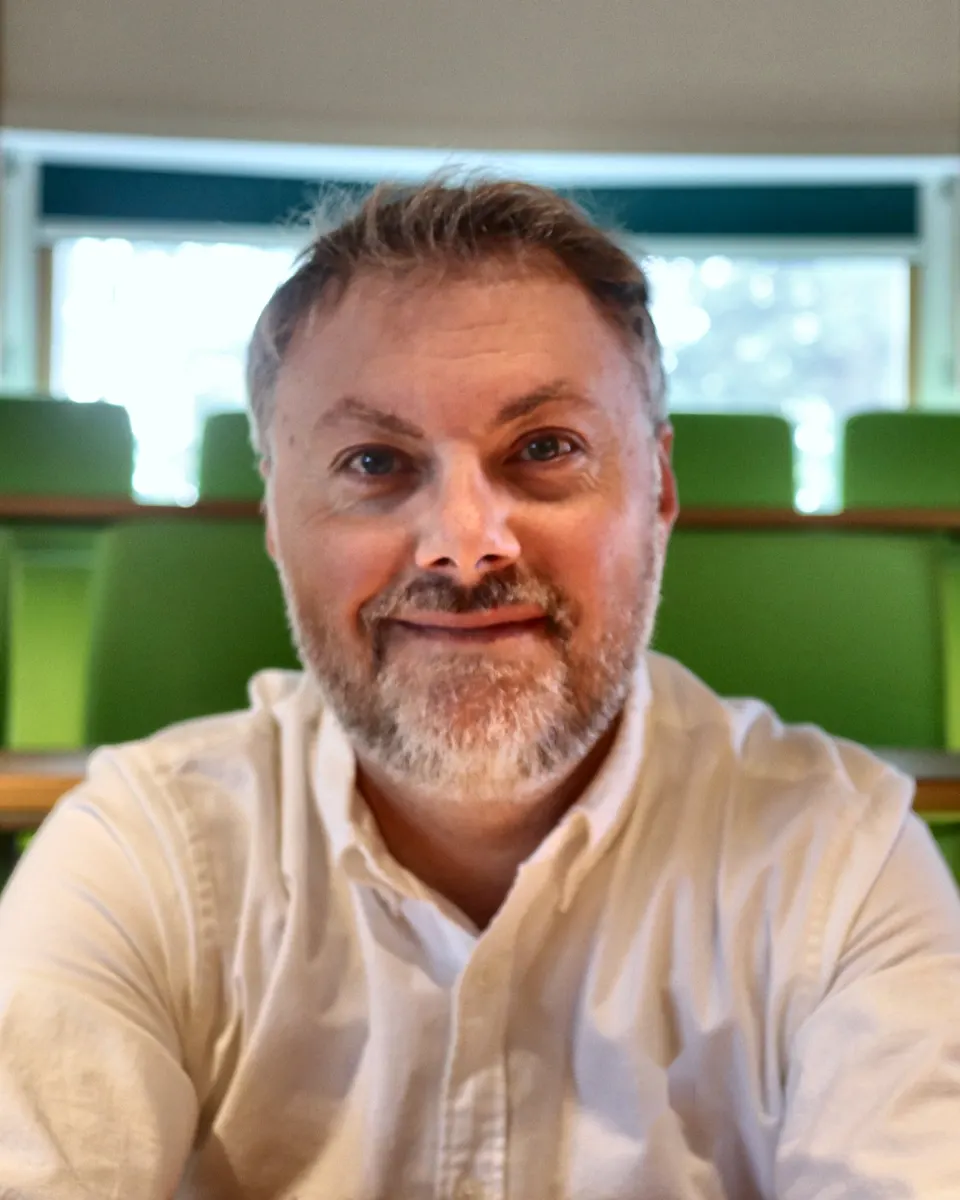 Dr John P. Mills, behavioural scientist and chartered psychologist, in a lecture theatre